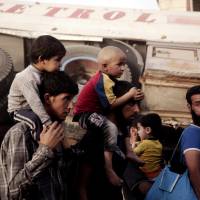 Men and children flee heavy fighting between Islamic State militants and Iraqi special forces in Mosul, Iraq, Wednesday. 'Stark choices' for 450,000 civilians trapped amid fighting in Mosul's Old Town: ICRC