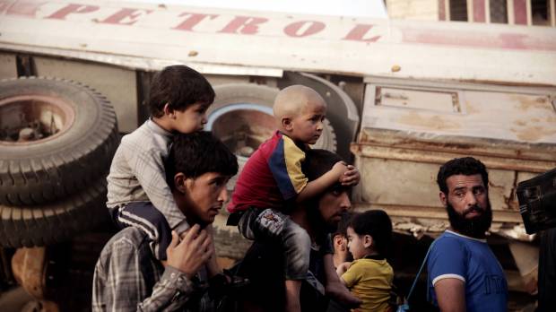 Men and children flee heavy fighting between Islamic State militants and Iraqi special forces in Mosul, Iraq, Wednesday. 'Stark choices' for 450,000 civilians trapped amid fighting in Mosul's Old Town: ICRC