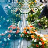 A visitor lays a wreath at the memorial for the victims of Nazi euthanasia in Berlin during its official inauguration on Sept. 2, 2014. German scientists to identify disabled victims of Hitler's euthanasia program