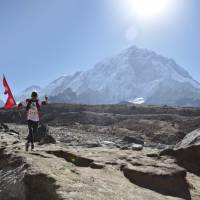 A Nepalese runs with his national flag during a marathon to mark the first conquest of Mount Everest, at Lobuche, near Everest base camp, Nepal, Monday. Nepal’s mountaineering community is celebrating the first conquest of Everest and a successful climbing season in which hundreds of climbers scaled the world’s highest peak. Monday is the 64th anniversary of the first successful climb of Everest by New Zealander Edmund Hillary and his Sherpa guide, Tenzing Norgay. Nepal fetes 64th anniversary of Everest conquest
