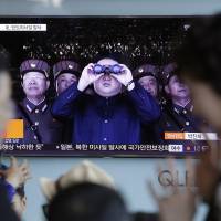 A TV news program showing an image of North Korean leader Kim Jong Un is seen at Seoul Railway Station in the South Korean capital Sunday. North Korea test-fires what could be new kind of longer-range missile