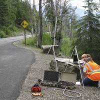 A National Park Service staffer sets up an acoustic recording station on Going-to-the-Sun Road in Glacier National Park, Montana, to capture the impact of traffic on acoustic conditions. Researchers find noise pollution caused by humans 'pervasive' in U.S. protected areas