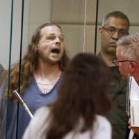 Jeremy Joseph Christian shouts as he is arraigned on Tuesday in Multnomah County Circuit Court in Portland, Oregon. Unease about white supremacy grows after train stabbings in liberal Oregon city with a racist past