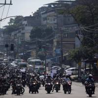 Motorcyclists who work on community transport protest during an operation in the Alemao slum complex after violent clashes between policemen and drug dealers in Rio de Janeiro Thursday. Amnesty warns of rising violence in Rio de Janeiro amid spike in killings by police