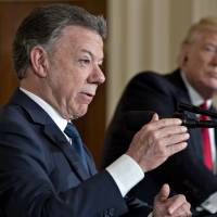 Juan Manuel Santos, Colombia’s president, speaks as U.S. President Donald Trump listens during a news conference with in the East Room of the White House in Washington on Thursday. As Colombia’s five-decade conflict with Marxist rebels winds down, Santos is battling to keep Washington’s interest in the country that receives the greatest amount of U.S. aid in the Americas. Trump welcomes Colombia's president to White House, seeks pressure on Caracas