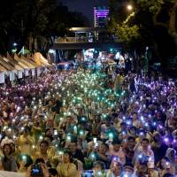 Supporters wave their mobile phone torches in the colors of the rainbow during a rally after Taiwan’s constitutional court ruled that same-sex couples have the right to legally marry, in Taipei, Taiwan, on Wednesday. Taiwan's top court recognizes same-sex marriage, a first in Asia