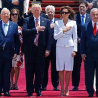 U.S. President Donald Trump and first lady Melania Trump listen to the their national anthem as they are welcomed by Israeli Prime Minister Benjamin Netanyahu (right, and Israeli President Reuven Rivlin upon their arrival at Ben Gurion International Airport in Tel Aviv on Monday. Trump greeted with selfies, abrupt politics on arrival in Tel Aviv