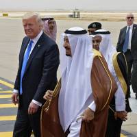 U.S. President Donald Trump is welcomed by Saudi King Salman bin Abdul-Aziz al-Saud Salman upon arrival at King Khalid International Airport in Riyadh on Saturday, followed by first lady Melania Trump. President Trump and Saudi King Salman meet in Riyadh