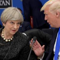 British Prime Minister Theresa May and U.S. President Donald Trump speak during a working dinner at the NATO summit in Brussels on Thursday. U.K. now sees 'special relationship' with U.S. as not so special