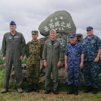 U.S. Pacific Command chief Adm. Harry Harris (second from left) takes a group photo with U.S. and Japanese military personnel, including Self-Defense Forces Chief of Staff, Joint Staff, Adm. Katsutoshi Kawano (third from left), during a visit Wednesday to Okinawa’s Yonaguni Island. Pacific Command chief visits Yonaguni radar outpost, reasserts freedom of navigation in South China Sea
