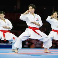 Hikaru Ono (center) and teammates perform in the 2016 World Senior Championships in female team kata in Linz, Austria in October. Her team won the gold medal. Oita woman pushes herself as firefighter, strives for karate Olympic gold