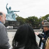 Members of the United Nations Conference on Disarmament Issues visit the Nagasaki Peace Park in December 2016. KYODO Tight schedule to keep Obama from visiting Nagasaki for August peace conference