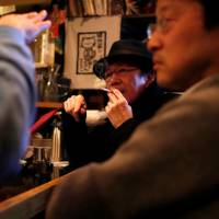 A man smokes at a pub in Tokyo in March. Many ruling Liberal Democratic Party lawmakers, supported by tobacco farmers and retailers, are opposed to a health ministry-drafted bill to ban indoor smoking. Pro-tobacco LDP clouds chances of indoor smoking ban in time for Tokyo Games