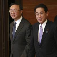 China’s State Councilor Yang Jiechi (left) is escorted by Foreign Minister Fumio Kishida at their meeting at the Iikura Guesthouse in Tokyo on Tuesday. Divide still large as Japan pushes to tighten noose on North while China emphasizes dialogue