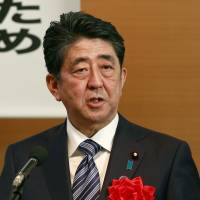 Prime Minister Shinzo Abe addresses the annual rally on revising the Constitution organized by conservative lawmakers in Tokyo on Monday. Japan's constitutional rebirth or reincarnation?
