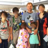 Two times two: James Cook is pictured with his estranged wife and their two pairs of twins, now aged 9 and 14. Three years after Japan signed Hague, parents who abduct still win