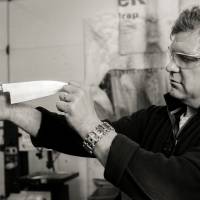 Murray Carter inspects a finished blade at his forge in Portland. Skills forged in Kyushu, blades forged in Oregon