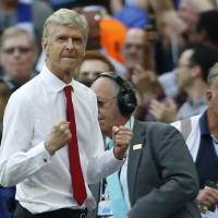 Arsenal manager Arsene Wenger celebrates at the final whistle of the League Cup final on Saturday. Arsenal defeated Chelsea to win the title. Arsenal gives Wenger new two-year contract