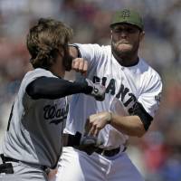 The Nationals’ Bryce Harper (left) and the Giants’ Hunter Strickland fight during their game on Monday in San Francisco. MLB hands down suspensions for Harper, Strickland after Nationals-Giants brawl
