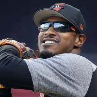 Baltimore’s Adam Jones warms up before the Orioles’ game against the Red Sox at Fenway Park in Boston on Tuesday. Orioles' Jones says racial taunts reflect wider problems