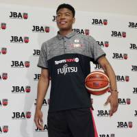 Rui Hachimura poses for photos at Tokyo’s National Training Center on Friday following a news conference. Hachimura hopes to get game back for Under-19 World Cup