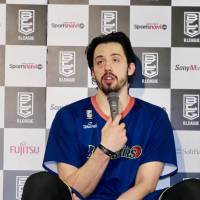 Yokohama B-Corsairs center Jason Washburn speaks to the media as his teammate Ken Takeda listens after Sunday’s game against the Hiroshima Dragonflies in Tokyo. B-Corsairs beat Dragonflies to maintain first-division status