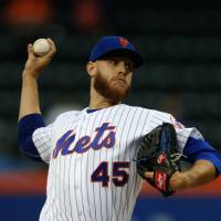 Mets starter Zack Wheeler pitches against the Giants on Tuesday in New York. The Mets won 6-1. Surging Mets too much for slumping Giants