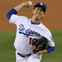 The Dodgers’ Kenta Maeda delivers a pitch against the Pirates on Wednesday in Los Angeles. Maeda comes within two outs of first complete game in bigs