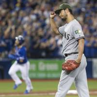 Texas starting pitcher Yu Darvish reacts after giving up a three-run home run to Toronto’s Jose Bautista in the fifth inning of the Rangers’ 3-1 loss to the Blue Jays on Saturday. Darvish's shaky control plays part in Texas' loss to Toronto