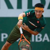Kei Nishikori serves during his first-round match against Australia’s Thanasi Kokkinakis at the French Open in Paris on Tuesday. Nishikori ousts Kokkinakis; Osaka exits French Open