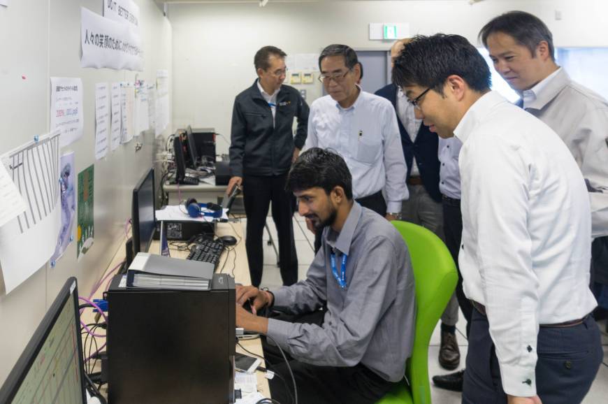 Intern Himanshu Tolani reporting his work progress to Tonichi Printing Co. colleagues.