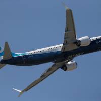 A Boeing 737 Max takes part in a flyng display at the first day of the 52nd Paris Air Show at Le Bourget airport near Paris Monday. Boeing launches new version of 737 with flurry of orders at subdued Paris air show