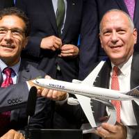 Vice President of Boeing Commercial Airplanes Ihssane Mounir (left) celebrates with United Airlines Senior Vice President of finance Gerry Laderman during a commercial announcement at the 52nd Paris Air Show at Le Bourget Airport near Paris Tuesday. Boeing gets United endorsement lift at airshow and ups demand forecast for new 737