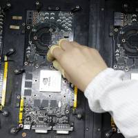 A worker checks circuit boards at a Hon Hai factory in Shenzhen, China. The assembler of iPhones plans to build plant in Wisconsin that could employ thousands of people. On heels of Trump visit, Foxconn, assembler of iPhones, eyes Wisconsin for plant