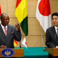 Guinea’s President Alpha Conde and Prime Minister Shinzo Abe attend a joint news conference at the Prime Minister’s Office in Tokyo on Tuesday. In Tokyo, Guinean President Alpha Conde calls for investment by Japanese firms