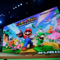 Bill Trinen (left), director of product marketing of Nintendo of America Inc., Shigeru Miyamoto (center), representative director and creative fellow at Nintendo Co., and Yves Guillemot, CEO of UbiSoft Entertainment SA, announce the “Mario + Rabbis Kingdom Battle” game at an Ubisoft event ahead of the E3 Electronic Entertainment Expo in Los Angeles on Monday. Nintendo unleashes a flurry of new games to fuel Switch momentum