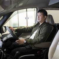 Yusuke Goto sits in a Serena minivan at a Nissan Motor dealership in April. Having avoided a crash with his Toyota Crown equipped with autopilot functions five years ago, Goto says it was an easy choice to go for Serena, touting similar features for a much cheaper price tag. Nissan wins converts in Japan with ¥3 million driver-assist minivan