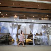 A woman arrives at a Nordstrom luxury department store, at The Mall of San Juan, in San Juan, Puerto Rico, in 2015. Members of Nordstrom stores’ founding family, including some top executives, say they’re considering buying out the 70 percent of the chain they don’t already own. Nordstrom’s stock, which has fallen in recent months, rebounded on the news Thursday. Stocks surge as Nordstrom family looks to buy out department store chain