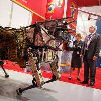 A Boston Dynamics “legged squad support system” robot is seen at the 34th Modern Day Marine Expo at Marine Corps Base Quantico in Virginia in 2014. SoftBank gains cutting-edge robotics with Boston Dynamics acquisition