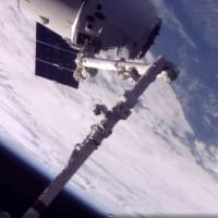 In this frame from NASA TV, a SpaceX Dragon arrives at the International Space Station on Monday, making an unprecedented second trip to the orbiting outpost. The Dragon supply ship, recycled following a 2014 flight, was launched from Florida on Saturday. SpaceX delivers first returning vehicle to ISS since shuttle