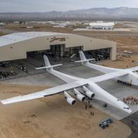 The Stratolaunch plane is pushed out of the hanger for the first time in the Mojave desert, California, Wednesday. The colossal rocket-launching plane touted as the future of space travel is closer to testing, having been rolled out of a hangar in the desert, its creators said. The project backed by billionaire Microsoft co-founder Paul Allen has been proceeding for about six years and was on track for its first launch demonstration as early at 2019. Enormous Stratolaunch rolled out for first time for preflight checks