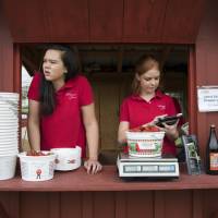Hannah Waring (left), a student at Loudoun Valley High School, and Abby McDonough, a student at Liberty University, work in the strawberry stand at Wegmeyer Farms in Hamilton, Virginia on May 23. Summer jobs are vanishing as U.S. teens spend more time in school and face competition from older workers. CEOs recall when teens like them actually worked summer jobs