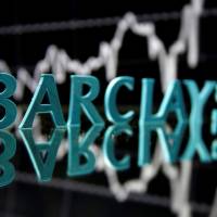 The Barclays logo is seen in front of displayed stock graph in this illustration taken on June 21. Traders who left banks for hedge funds heading back to banks