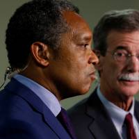 District of Columbia Attorney General Karl Racine (left) and Maryland Attorney General Brian Frosh conduct a live television interview after their news conference to announce their lawsuit against U.S. President Donald Trump on the issue of the U.S. Constitution’s emoluments clauses and Trump’s business ventures, in Washington Monday. Trump sued over business dealings, accused of Constitutional violations