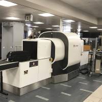 In this Wednesday photo provided by American Airlines, a Transportation Security Administration officer operates an L3 ClearScan baggage screener, featuring 3-D scanning technology, at a checkpoint at Phoenix Sky Harbor International Airport, in Phoenix, Arizona. The TSA says the technology improves the ability to find bombs. TSA tests 3-D CT scanner in bid to boost bomb-detecting for carry-ons