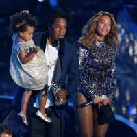Jay-Z presents the Video Vanguard Award to his wife Beyonce as he holds their daughter Blue Ivy during the 2014 MTV Video Music Awards in Inglewood, California, on Aug. 24, 2014. Beyonce gives birth to twins