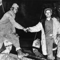 This Oct. 25, 1942, photo provided by the U.S. Army Corps of Engineers Office of History shows Cpl. Refines Slims, Jr. (left) and Pvt. Alfred Jalufka shaking hands at the “Meeting of Bulldozers” for the ALCAN Highway in the Yukon Territory in Beaver Creek, Alaska. Nearly 4,000 segregated black soldiers helped build the highway across Alaska and Canada during World War II, a contribution largely ignored for decades but drawing attention as the 75th anniversary approaches. Alaska salutes segregated black soldiers' WWII work to build Alcan Highway