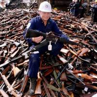 Norm Legg, a project supervisor with a local security firm, holds up a rifle that was similar to the one used in the Port Arthur massacre and had been handed in for scrap in Melbourne during a nationwide gun amnesty program on Sept. 8, 1996. Australia, fearing extremist attacks, to hold first gun amnesty in 20 years