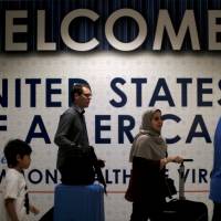 International passengers arrive at Washington Dulles International Airport in Dulles, Virginia, on Monday after the U.S. Supreme Court granted parts of the Trump administration’s emergency request to put its travel ban into effect later in the week pending further judicial review. Narrowed Trump travel ban could sow confusion in U.S. and abroad, experts say
