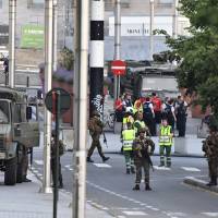 Belgian Army soldiers and police patrol outside Central Station after a reported explosion in Brussels on Tuesday. Belgian media are reporting that explosion-like noises have been heard at the train station, prompting the evacuation of a main square. Man shouting 'Allahu Akbar' shot dead after he sets off small explosive at Brussels station in terror attack